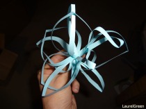 a photo of a paper flower being held in a hand