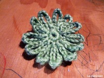 a photo of a green crocheted flower